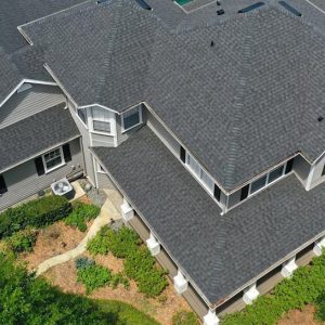 Roofers working on a shingle roof